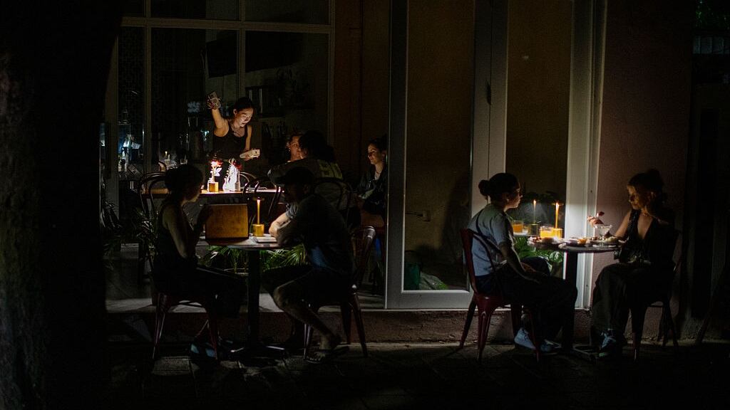 People eat at a restaurant after power goes out across Puerto Rico.